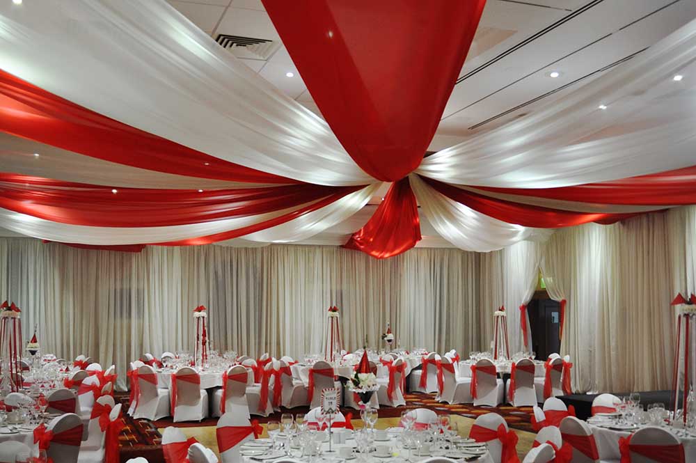 Circus style wedding ceiling drapery in Red and White voile at Marriott Hotel Swindon Corporate event