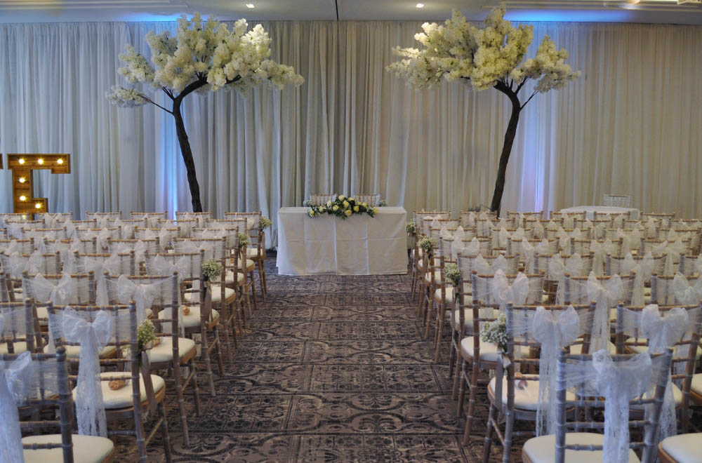3.2m Ivory White blossom trees at a wedding ceremony at De Vere Tortworth Court with wall drapes